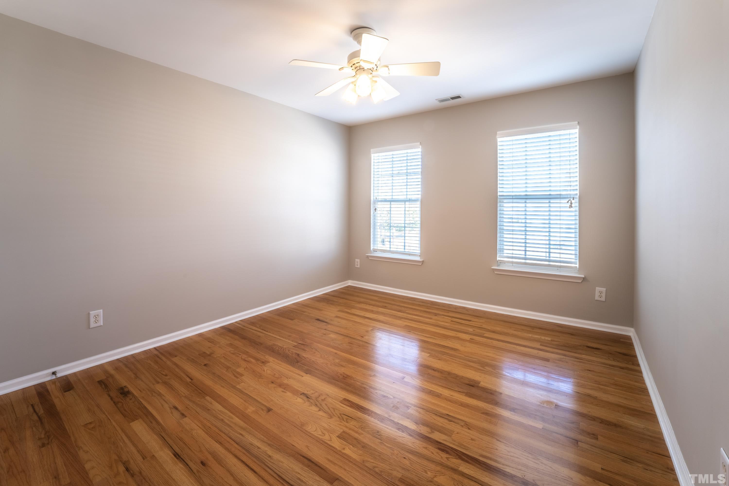 5455 Wind Mountain Lane Raleigh, NC 27613 - Photo 17 of 28 wooden floor in an empty room with a window