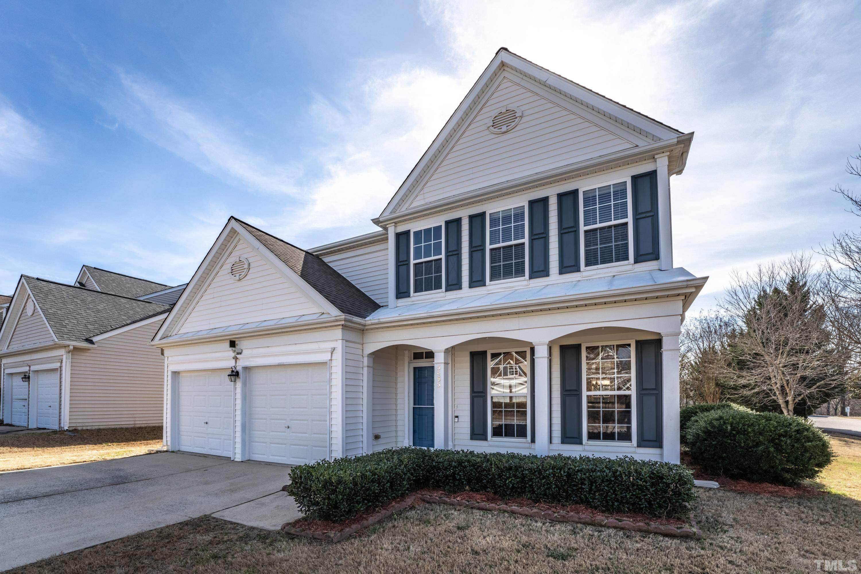 5455 Wind Mountain Lane Raleigh, NC 27613 - Photo 2 of 28 a front view of a house with a yard and garage