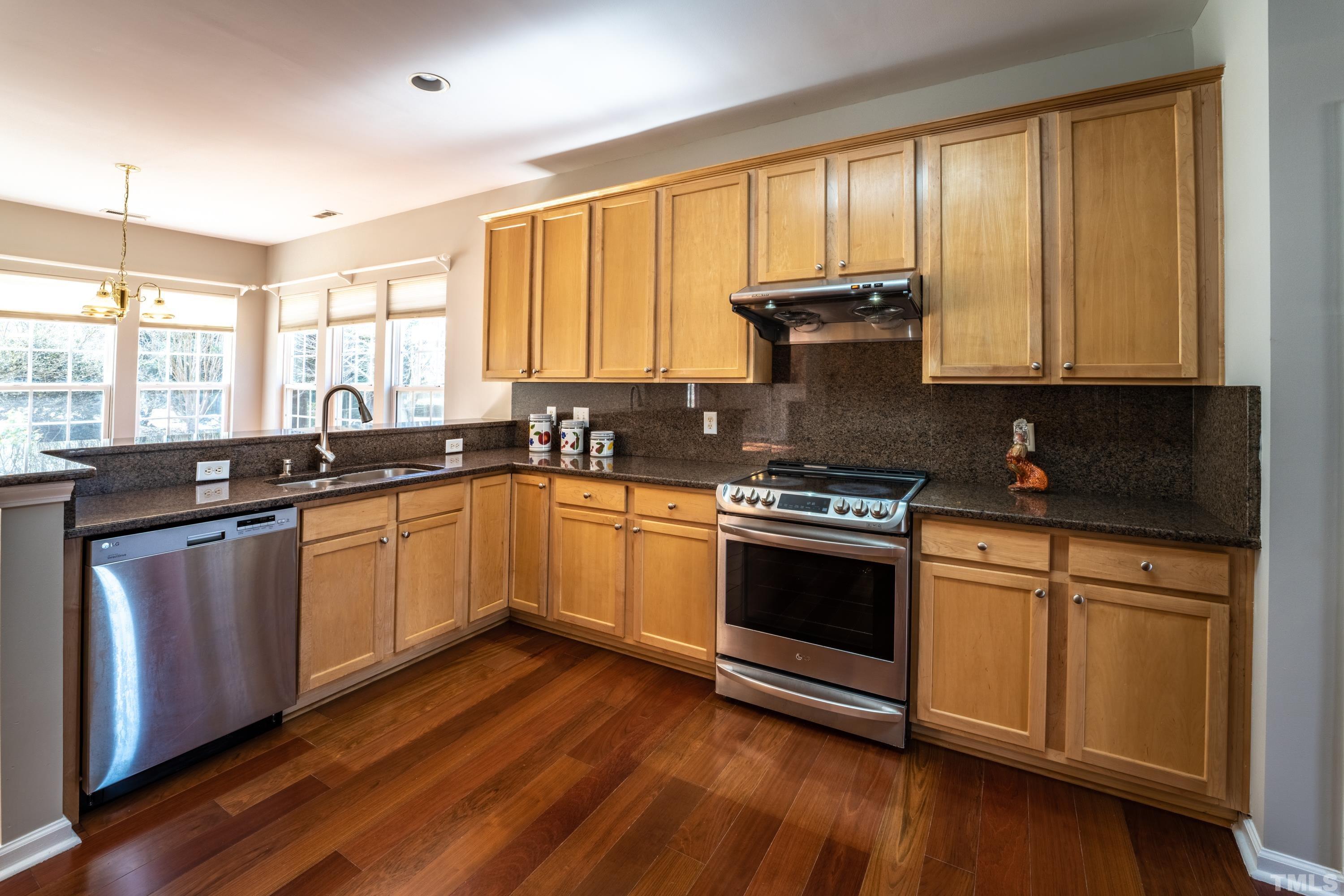 5455 Wind Mountain Lane Raleigh, NC 27613 - Photo 5 of 28 a kitchen with a sink stove top oven and cabinets