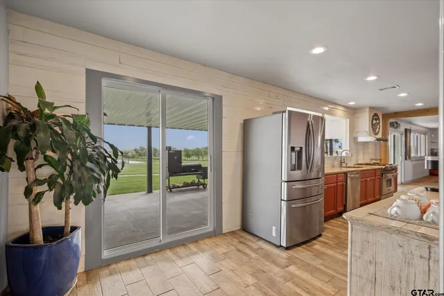 a bedroom with a large bed and flat tv screen on dresser