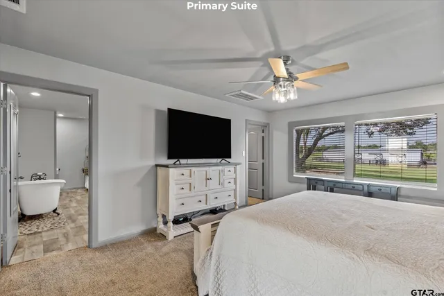 a living room with lots of furniture and kitchen view