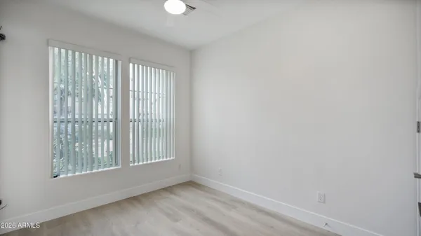 a bedroom with a bed and a painting on the wall