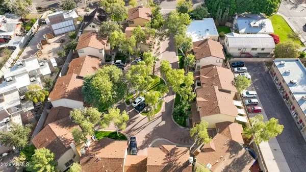 an aerial view of a residential apartment building with a yard and plants