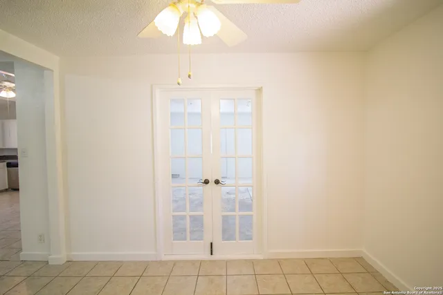 a kitchen with a refrigerator and a stove top oven