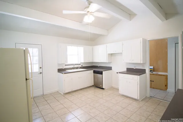 a bathroom with a granite countertop sink a toilet and a mirror