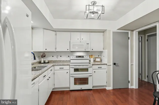 a kitchen with a stove oven and white cabinets