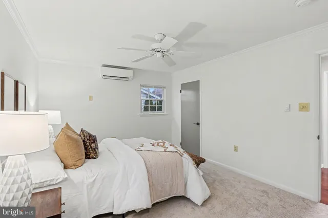 a bedroom with a bed and a ceiling fan