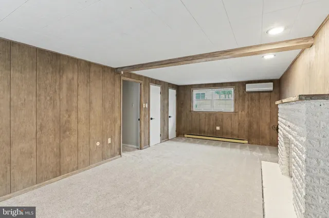 a view of an empty room with a fireplace