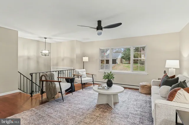 a living room with furniture a window and a table