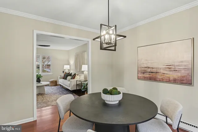 a view of a dining room with furniture a chandelier and wooden floor