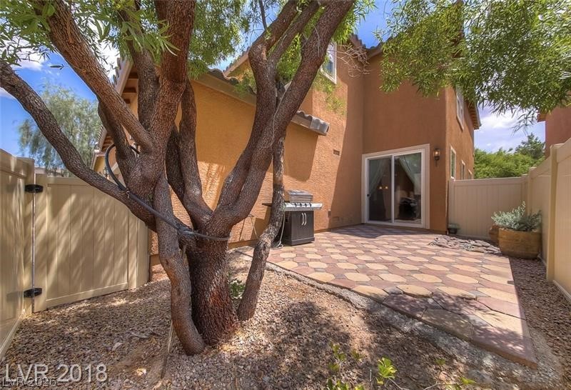 3144 Whitfeild Avenue Henderson, NV 89044 - Photo 32 of 55 A private backyard oasis features a paved patio, perfect for outdoor entertaining.