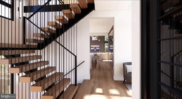 a view of entryway and hall with wooden floor