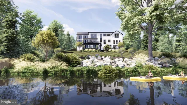 an aerial view of a house with a yard and lake view