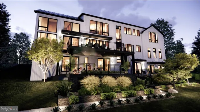 a front view of a residential apartment building with a yard