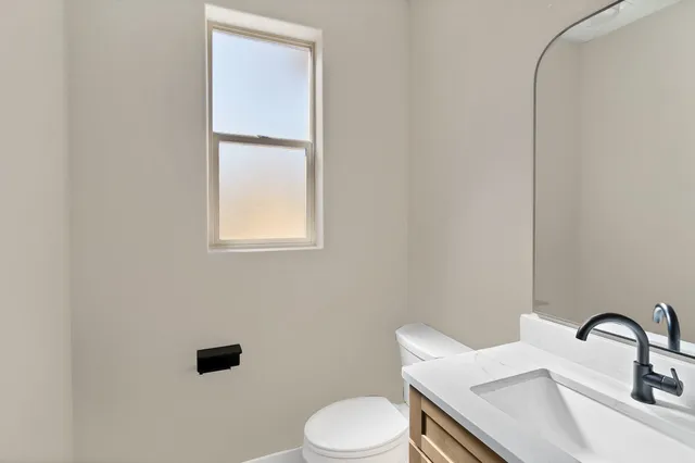 a bathroom with a sink toilet and mirror