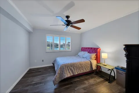 a bathroom with a granite countertop sink vanity mirror and toilet