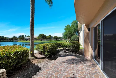 a view of a swimming pool with a garden and lake view
