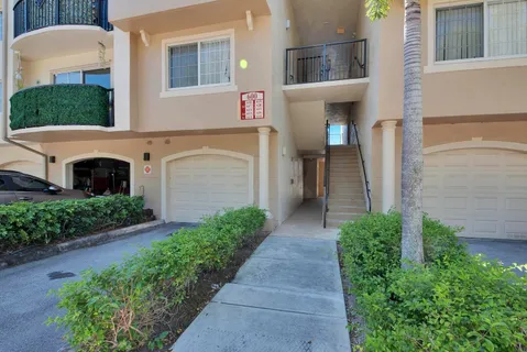 a front view of a building with a garden