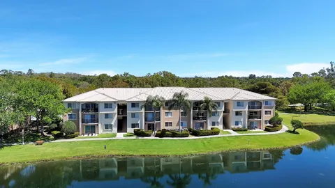 an aerial view of a house with swimming pool and outdoor seating
