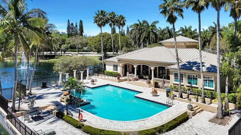 a aerial view of a house with swimming pool lake view and mountain view