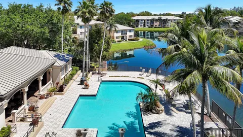 a view of a house with swimming pool and sitting area