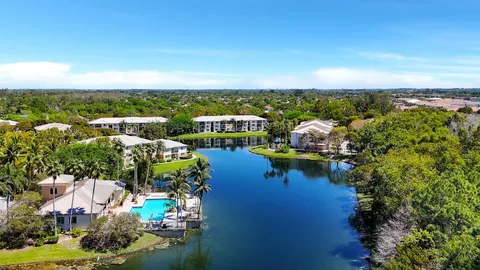 an aerial view of a house with a yard swimming pool and outdoor seating