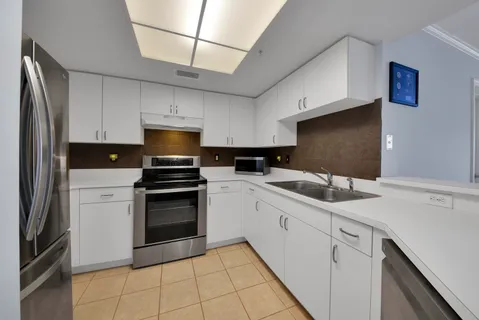 a kitchen with cabinets appliances and a sink