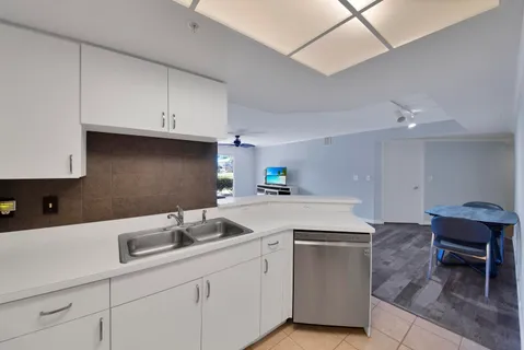 an aerial view of residential houses with outdoor space and lake view