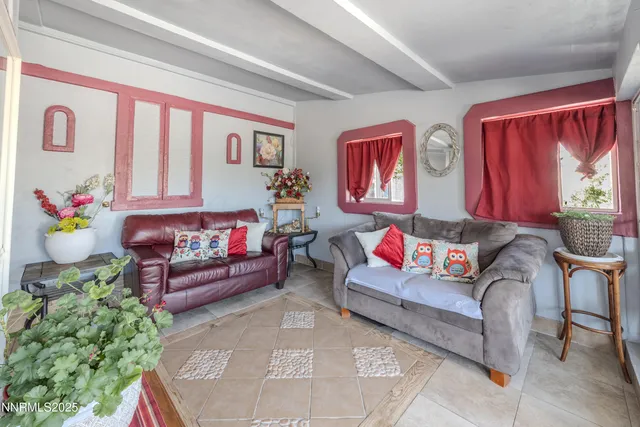 a living room with furniture and flowers