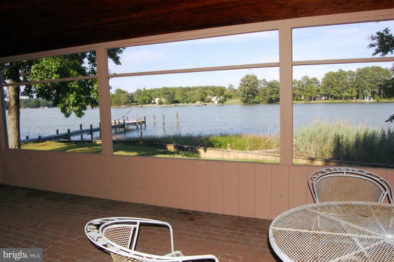 6937 Pea Neck Road St. Michaels, MD 21663 - Photo 11 of 22 a view of roof deck with table and chairs