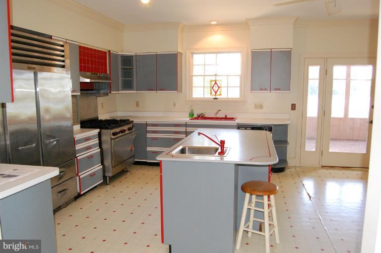 6937 Pea Neck Road St. Michaels, MD 21663 - Photo 16 of 22 a kitchen that has a sink stainless steel appliances a counter space and a window