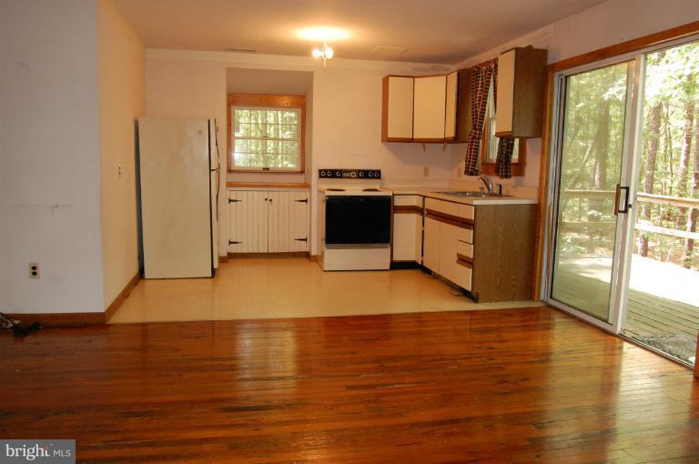 6937 Pea Neck Road St. Michaels, MD 21663 - Photo 20 of 22 a kitchen with a sink wooden floor and a large window