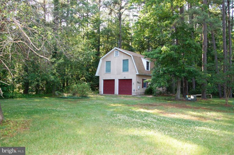 6937 Pea Neck Road St. Michaels, MD 21663 - Photo 6 of 22 a view of a house with a yard and large trees