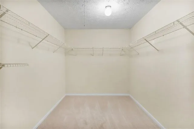 a spacious bathroom with a granite countertop sink a large mirror and a shower