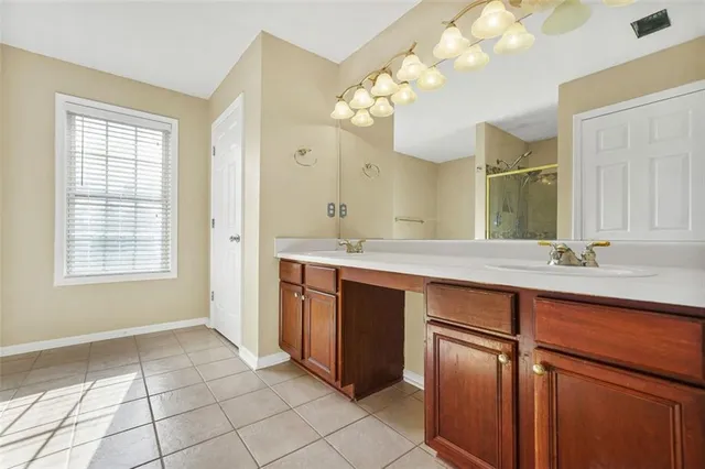a spacious bathroom with a double vanity sink mirror and double