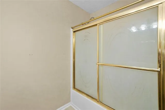 a bathroom with a glass shower door