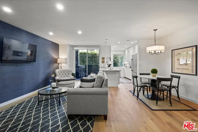 a living room with furniture a dining table and a flat screen tv