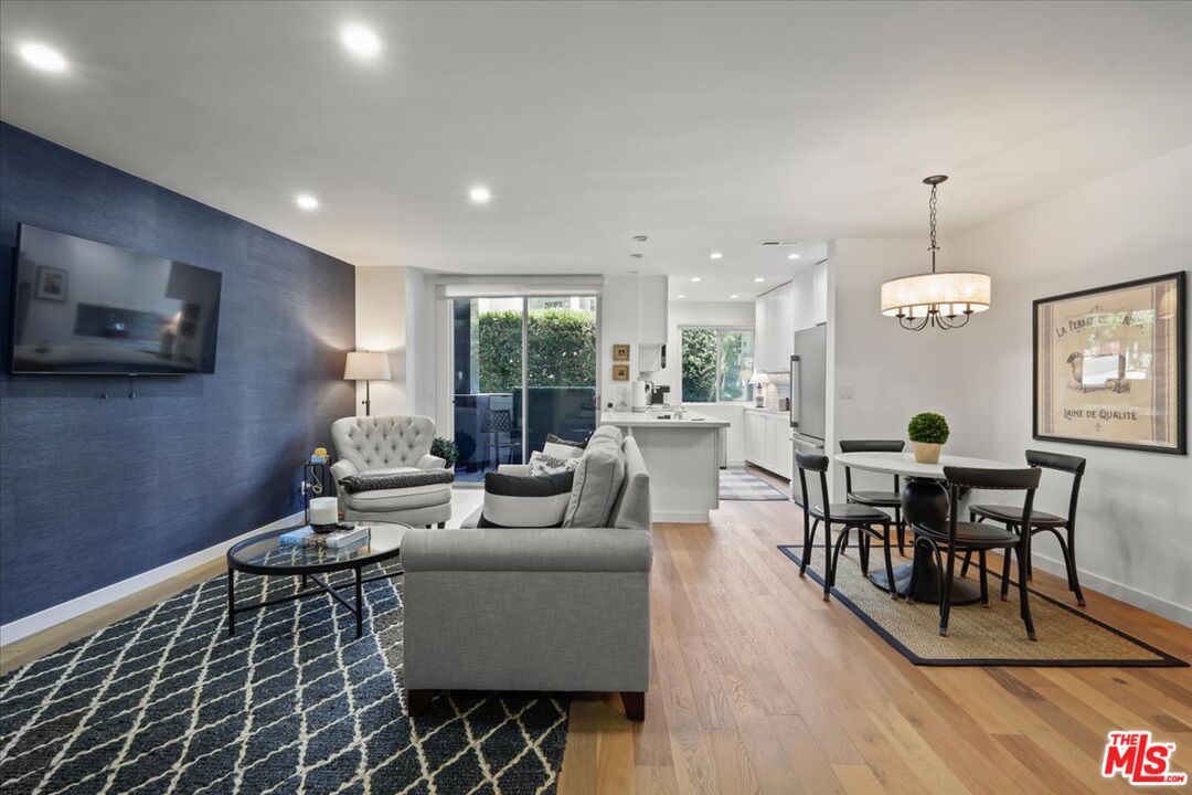 7250 Franklin Avenue, Unit 101 Los Angeles, CA 90046 - Photo 1 of 33 a living room with furniture a dining table and a flat screen tv