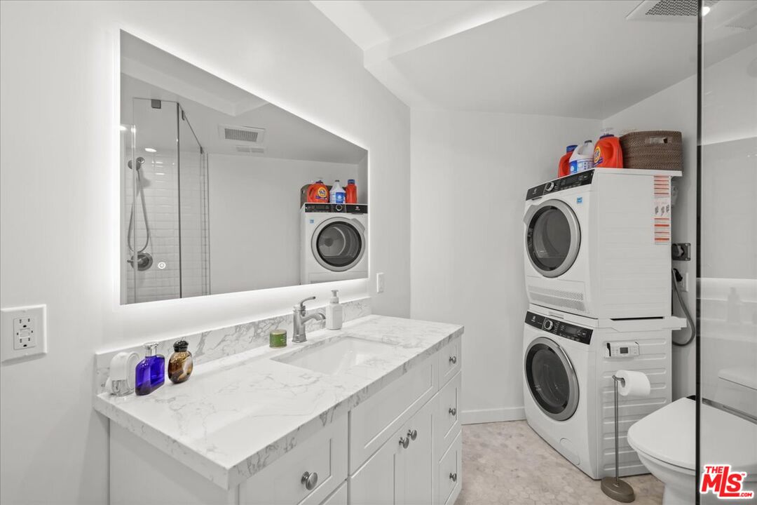 7250 Franklin Avenue, Unit 101 Los Angeles, CA 90046 - Photo 12 of 33 a utility room with sink dryer and washer
