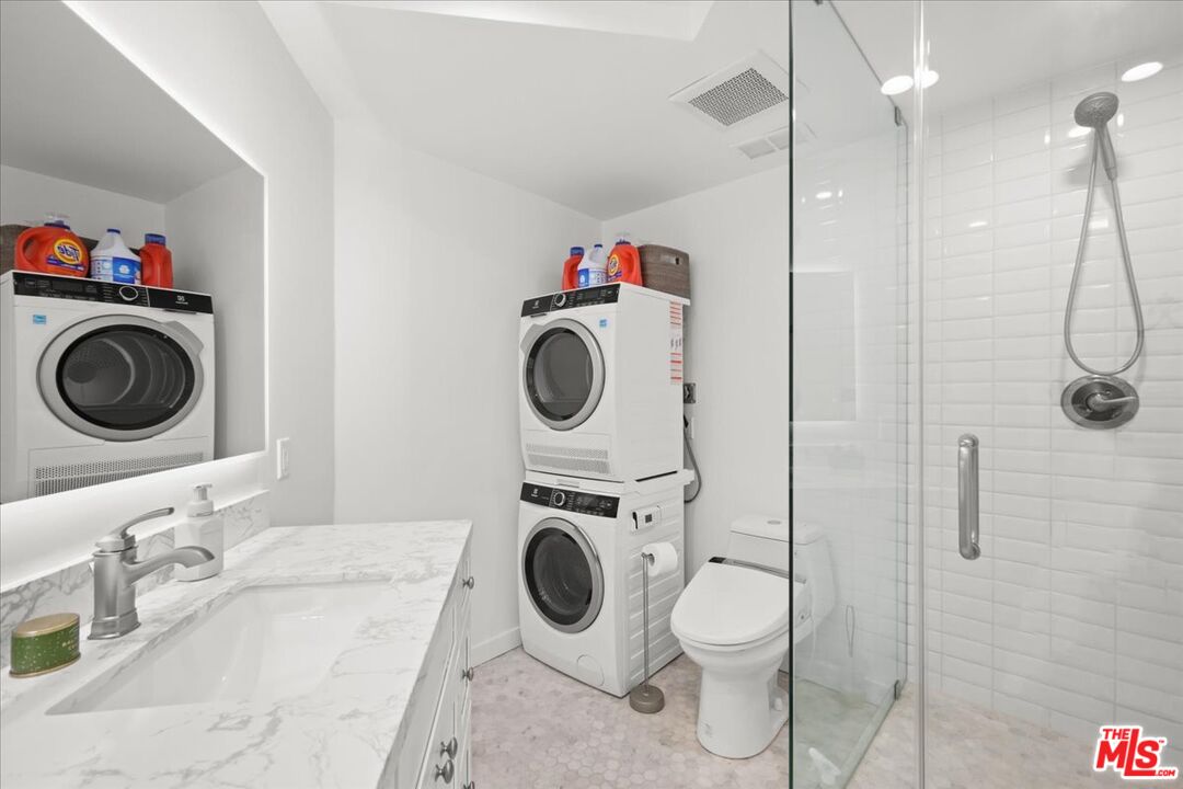 7250 Franklin Avenue, Unit 101 Los Angeles, CA 90046 - Photo 13 of 33 a utility room with dryer washer and a view of bathroom
