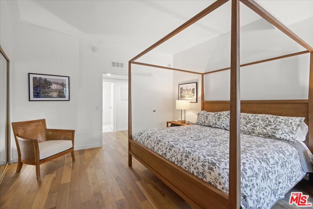 7250 Franklin Avenue, Unit 101 Los Angeles, CA 90046 - Photo 18 of 33 a bedroom with a bed and wooden floor