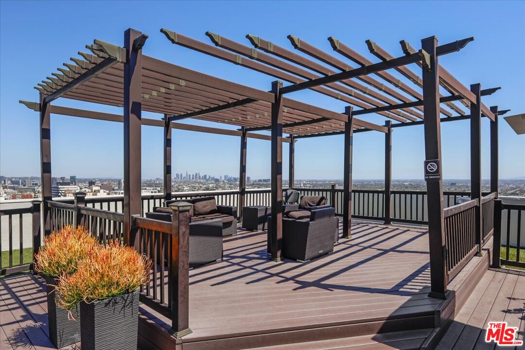 7250 Franklin Avenue, Unit 101 Los Angeles, CA 90046 - Photo 27 of 33 a view of balcony with wooden floor and outdoor seating