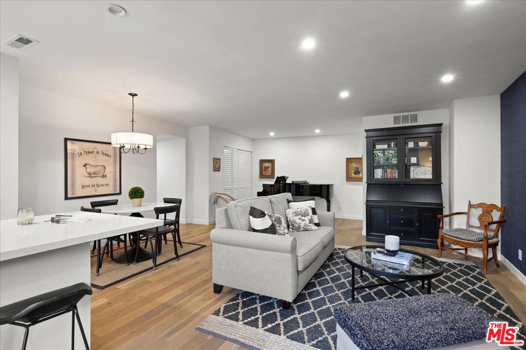 7250 Franklin Avenue, Unit 101 Los Angeles, CA 90046 - Photo 4 of 33 a living room with furniture a rug and a chandelier