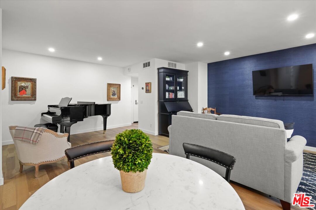 7250 Franklin Avenue, Unit 101 Los Angeles, CA 90046 - Photo 7 of 33 a living room with furniture and a flat screen tv