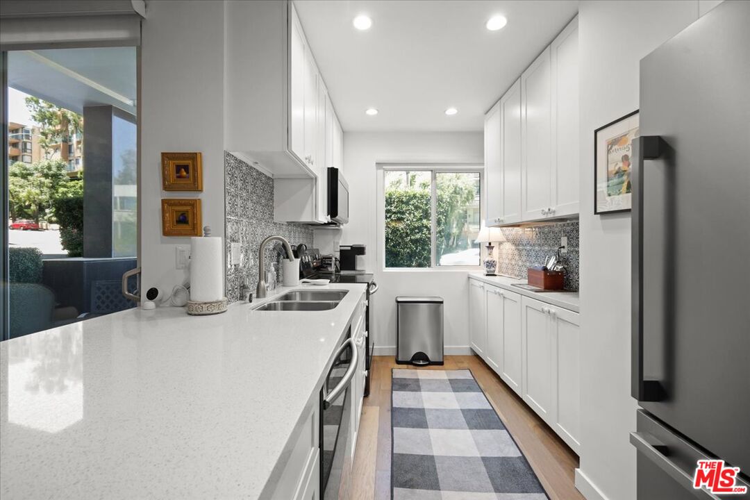 7250 Franklin Avenue, Unit 101 Los Angeles, CA 90046 - Photo 9 of 33 a kitchen with a sink a stove a refrigerator and cabinets
