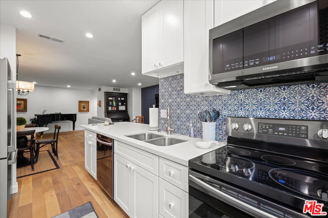 7250 Franklin Avenue, Unit 101 Los Angeles, CA 90046 - Photo 10 of 33 a kitchen with a stove and a microwave