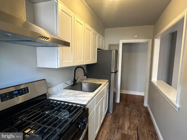 a kitchen with a refrigerator and a sink