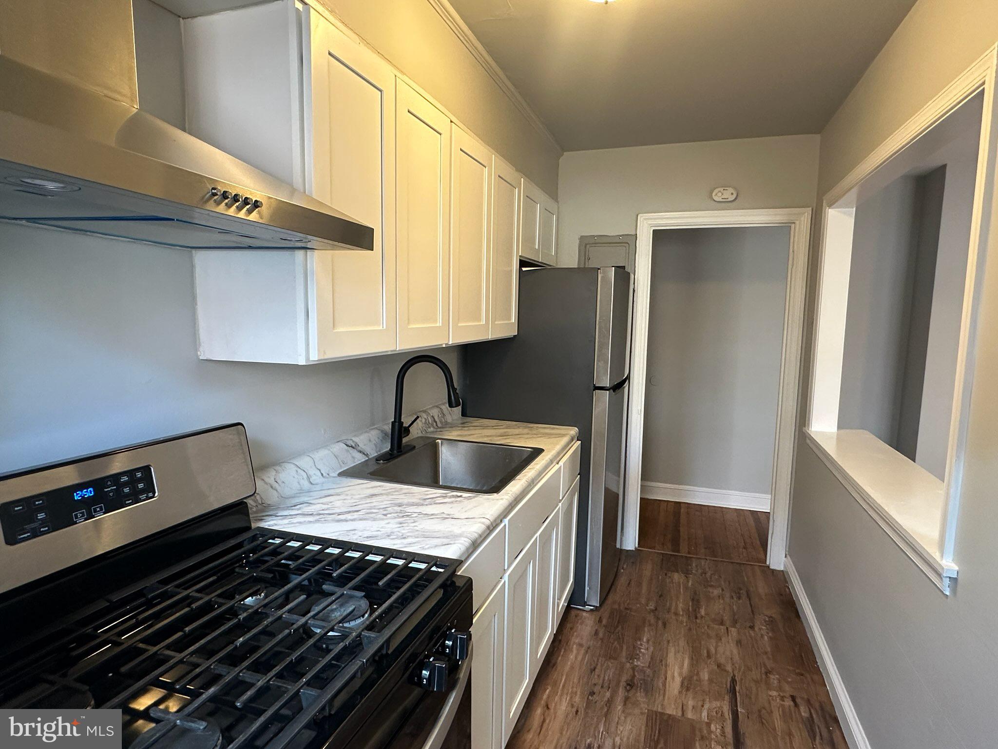 a kitchen with a refrigerator and a sink