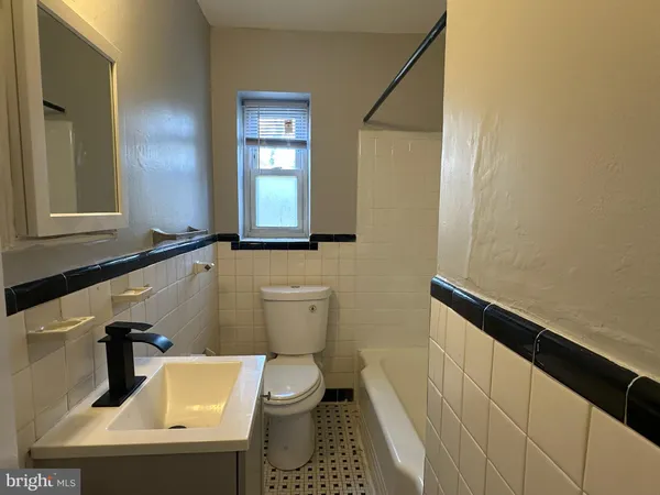 a bathroom with a sink a toilet and mirror