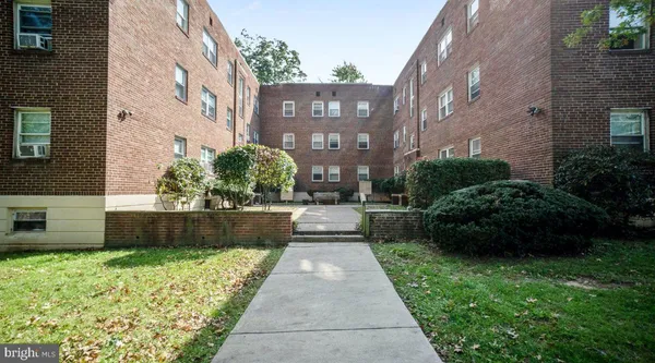 a view of a brick house with a yard